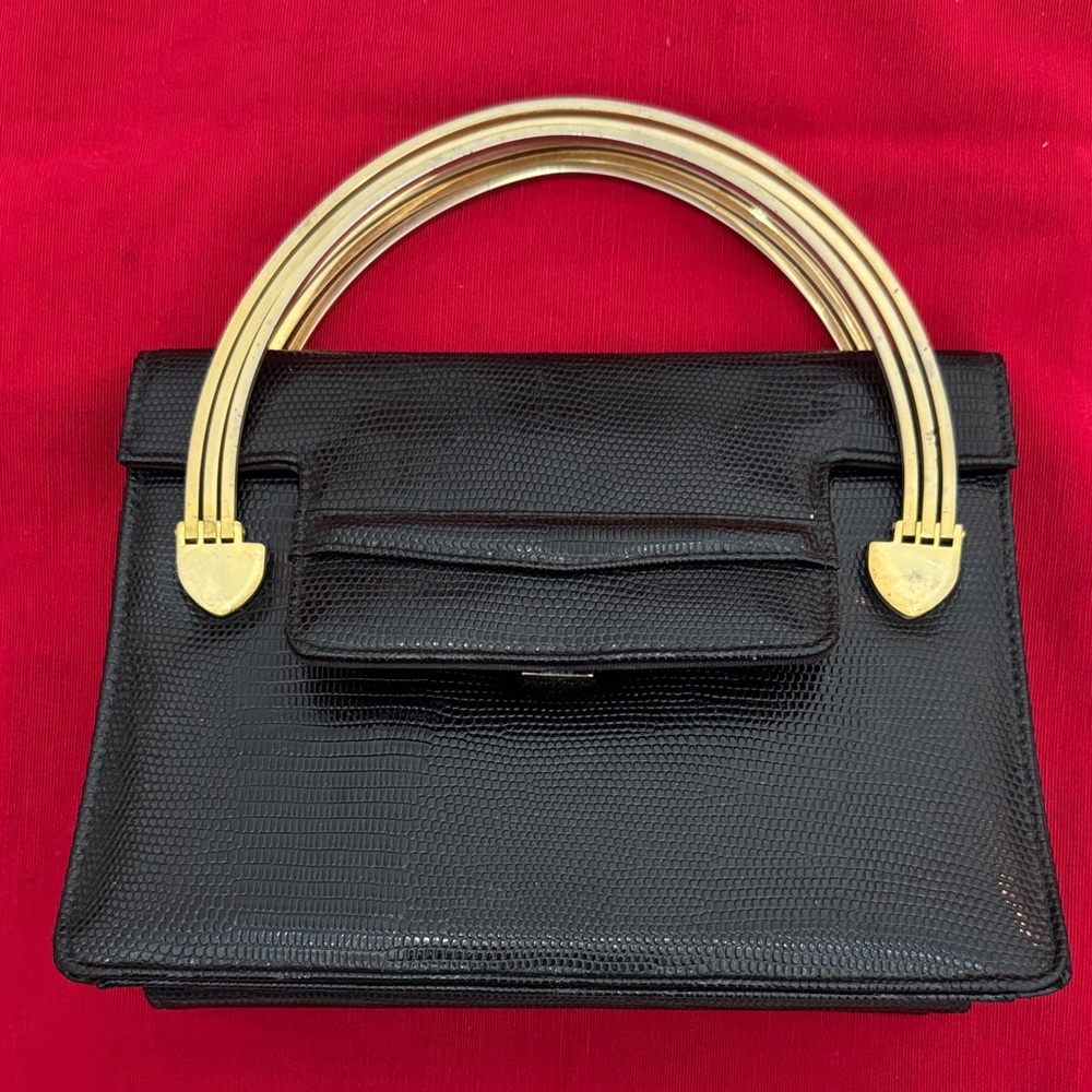 Meyers Elegant Black Handbag with Gold Accents that has 3 bars on each side (mlb
